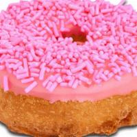 Pink Sprinkles Iced Cake · Cake donut with pink icing and dipped in pink sprinkles.