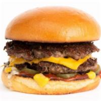 The Deluxe Burger · Smashed double patties, dashi onions, American cheese, pickle chips, mustard and ketchup on ...