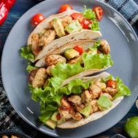 Chicken Taco · Delicious chicken taco with lettuce, cheese, and sauce.