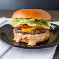 Cheeseburger · A 1/3 lb Burger with American cheese on a brioche bun with lettuce, tomato & Big Sauce.