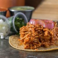 Tinga · Shredded chicken marinated in a tomato chipotle sauce 