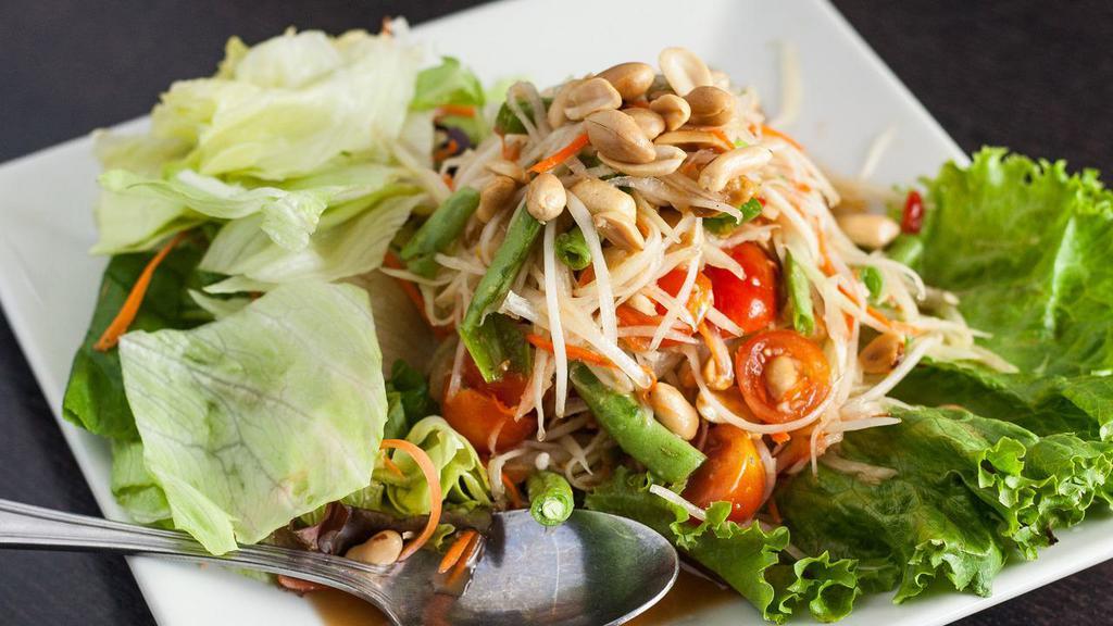 Papaya Salad (Som Tum) · Spicy. Green papaya, green bean, tomatoes and peanut tossed in spicy garlic lime dressing.