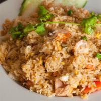 Salmon Fried Rice · Cube salmon wok fried with eggs, peas & carrots, tomatoes, fresh cucumber.
