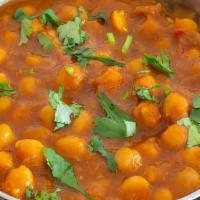 Chana Masala · Gluten-free. Vegetarian. Boiled chickpeas cooked in a deep-roasted tomato-onion gravy, spike...