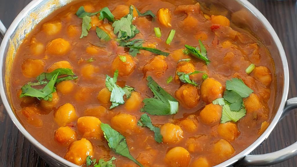 Chana Masala · Gluten-free. Vegetarian. Boiled chickpeas cooked in a deep-roasted tomato-onion gravy, spiked with tamarind.