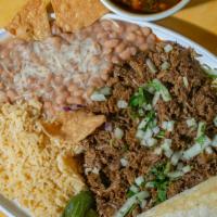 Birria Plate · Served with rice, beans, cilantro, onion, tortillas, and consomé.