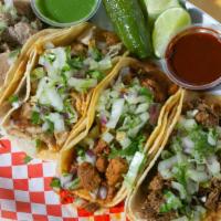 Soft Tacos · Two small corn tortillas with your choice of meat, onion and cilantro on top.