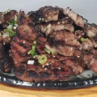 Grilled Pork · Korean style marinated pork with sweet soy sauce on sliced onion.