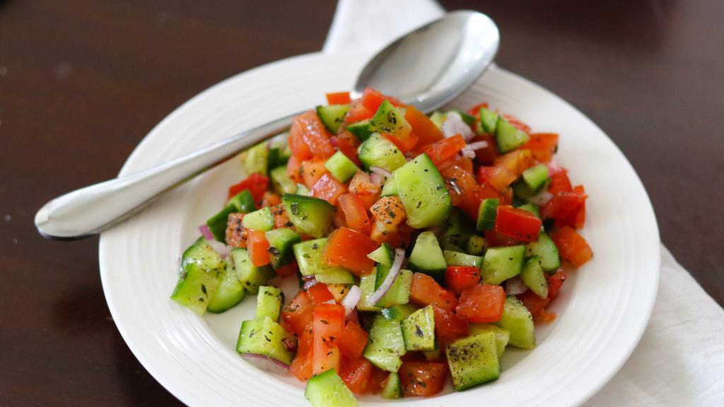 Salad Shirazi · Diced Persian cucumber, diced tomato, onion, mint, salt, pepper, olive oil and lemon juice.