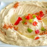 Hummus · A blend of mashed chick peas with tahini, garlic, lemon, olive oil.