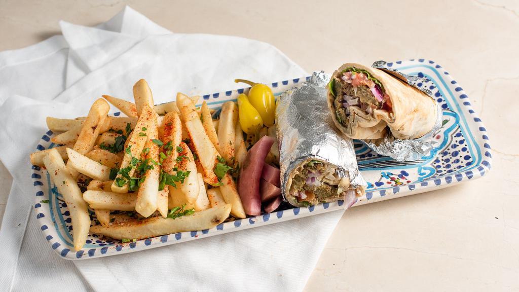 Beef Shawarma · Seasoned beef wrapped in a pita with tahini, lettuce, tomatoes, onions, & parsley.