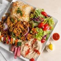 Chicken Shawarma · Delicious chicken shawarma marinated and grilled. served with rice. salad. and veggies.