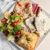 Lemon Chicken · Grilled chicken filets tossed in a creamy sauce served with rice, salad. and veggies.