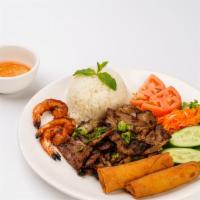 Cơm Tôm, Thịt Nướng & Chả Giò (Heo) · Charbroiled Shrimp, Eggrolls & Pork with Rice.