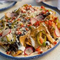 Nachos El Supremo · House- made chips with Mexican cheeses, salsa verde, black beans, crema, radishes, pickled j...