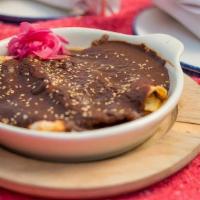 Enchilada De Mole · Cheese stuffed tortillas covered in the slow-cooked mole (contains nuts) and topped with bla...