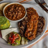 Ranchero Steak · Our salute to Tex-Mex - 12oz grilled ribeye, ranchero sauce, house made flour tortillas, que...