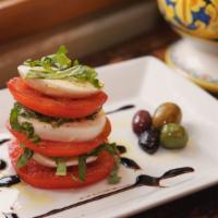 Caprese · Fresh Italian mozzarella, tomatoes, basil, extra virgin olive oil and olives.