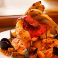 Cioppino Alla Livornese · Baby lobster tails, clams, mussels, shrimp, scallops, calamari, fish in a spicy tomato sauce...