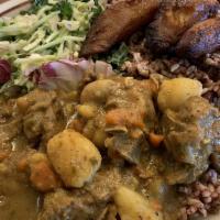 Curry Goat · Served with rice, veggies, plantains.