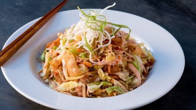 Chin Chin Chinese Chicken Salad · Shredded iceberg lettuce, chicken breast, scallions, carrots, toasted almonds, crispy rice  noodles and wonton crisps  with our signature housemade red ginger dressing.