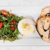 Burrata Caprese · Burrata, arugula, grape tomatoes, Italian vinaigrette dressing, housemade pesto, and extra v...