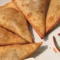 Vegetarian  Curry Puffs · Puff pasty fill with potatoes, carrots and yellow curry powder served with cucumber salad.