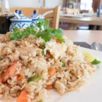 Thai Fried Rice · Pan-fried rice with egg, onions, peas, tomatoes and green onions.