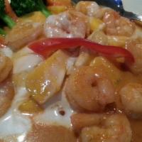Mango Fantasy · Creamy red curry sauce  & peanut sauce served over mango and prawns with broccoli and carrots.