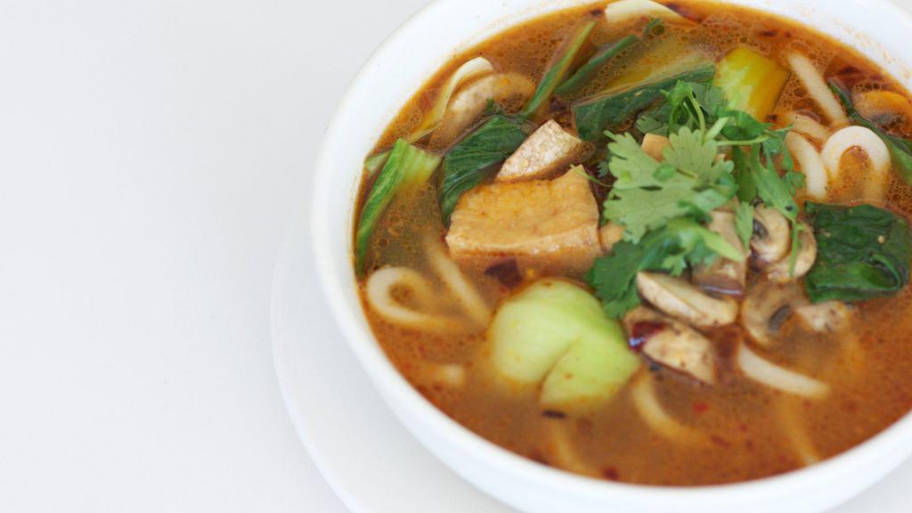 Spicy Udon Noodle Soup · Udon noodles, cabbages, mushrooms, and tofu in a spicy broth. Topped with cilantro.