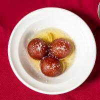 Gulab Jamun · Donut like balls in sweet syrup.