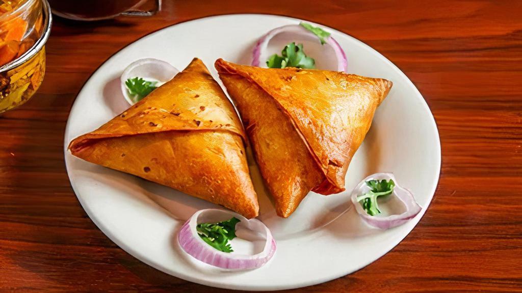 Meat Samosa · Flour tortillas stuffed with minced chicken or lamb, peas, onions, herbs and spices deep-fried.