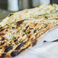 Naan · Traditional Indian bread baked in tandoori oven.