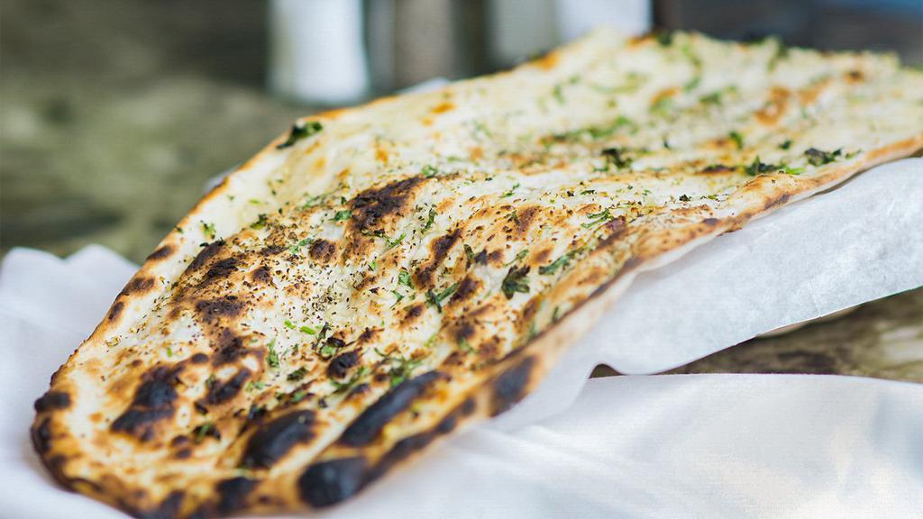 Naan · Traditional Indian bread baked in tandoori oven.