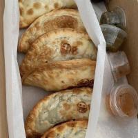 The Dozen · Get a taste of all our flavors or mix and match your favorite empanadas. That's 12 empanadas...
