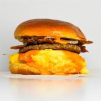 Brioche, Bacon, Sausage, Egg And Cheese Sandwich · 2 scrambled eggs, melted American cheese, breakfast sausage, bacon, and Sriracha aioli on a ...