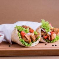 Chicken Shawarma Sandwich · Thinly carved marinated chicken, lettuce, tomatoes hummus and garlic sauce.