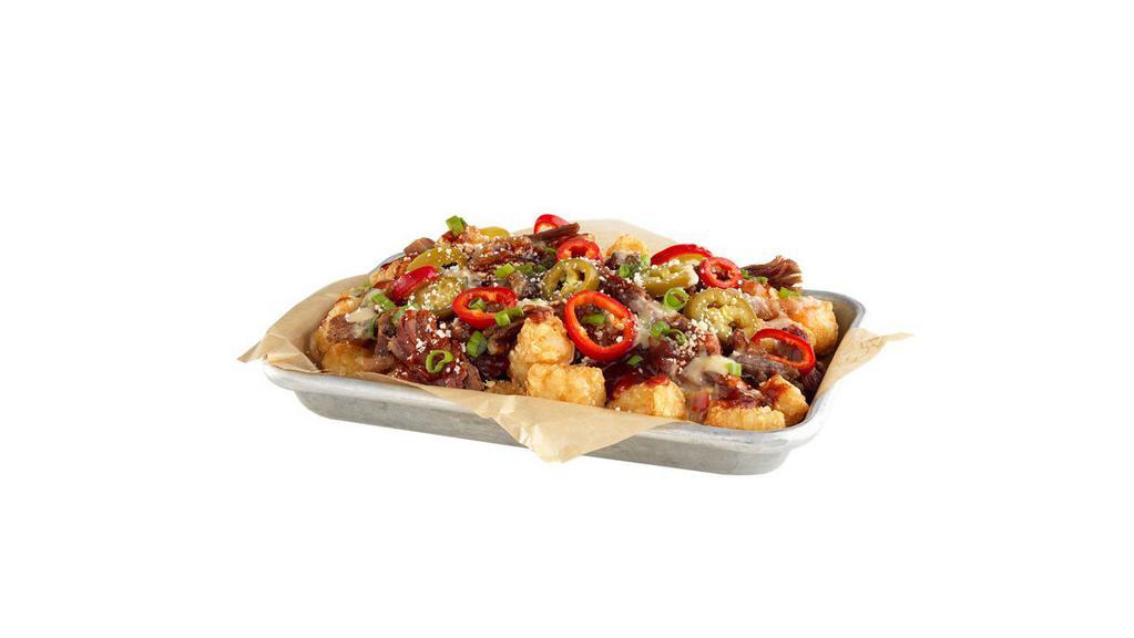 Dirty Dub Tots · Tater tots/smoked pulled brisket / grilled onions / hatch queso / smoky adobo / Honey BBQ / pickled hot peppers / green onions / cotija cheese