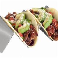 Brisket Tacos · Smoked pulled brisket / sweet BBQ / grilled onions / house-made guacamole / house-made pico ...