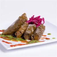 Dolmades (5) · Vine leaves stuffed with basmati rice, herbs and spices.