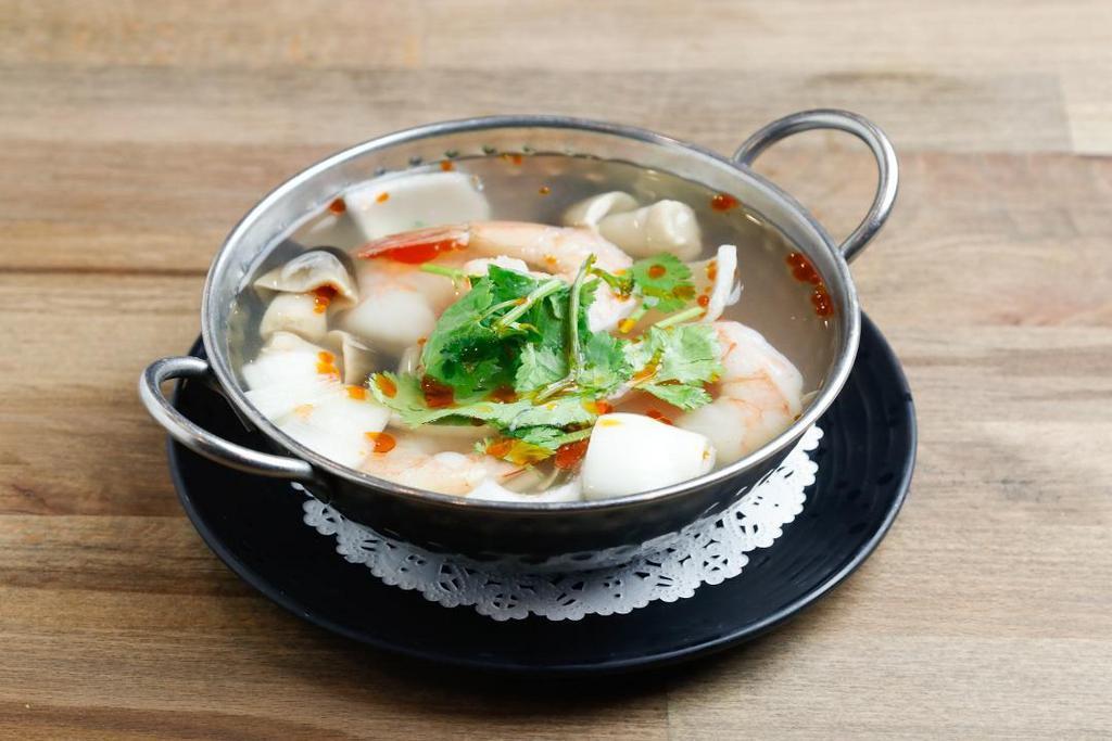 Tom Yum Soup [Cup] · Spicy and sour soup with fresh chili, mushroom, lemon grass, lime leaves, tomato and galangal