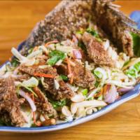 Yum Pla Tod · Deep fried whole fish in mix house dressing of spicy lime juice with apple, red shallot, cil...