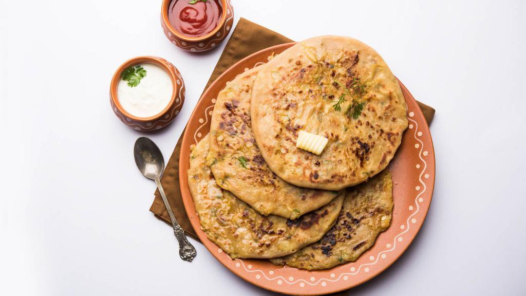 Aloo Paratha · Freshly prepared traditional paratha, stuffed with spiced potatoes.