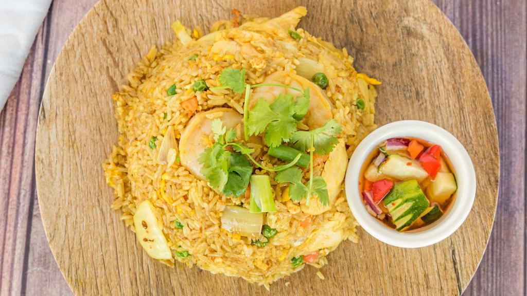 Pineapple Fried Rice · Stir-fried rice with chicken, shrimp, egg, cashew nuts, pineapple onion and touch of curry powder.