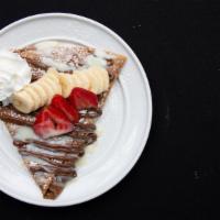 American Crepe · Banana, strawberries, Nutella, and condensed milk. Include whipped cream and sugar powder.