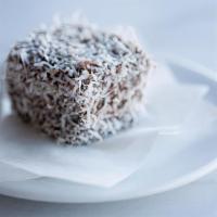 Lamington · Sponge cake rolled in chocolate ganache, sprinkled with coconut flakes.