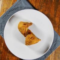 001-Vegetable Samosa · Spicy seasoned potatoes and peas wrapped in a light pastry.