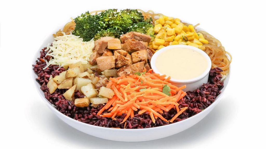 Bibi Fan Favorite · Sweet, creamy and crunchy, this bowl puts all of our best-selling items in one dish.  Marinated chicken, potatoes, carrots, cheese, corn and broccoli over a half japchae half purple rice base, finished with yum yum sauce.