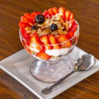 Napoleon Parfait · Low fat vanilla yogurt, granola served with seasonal berries, almonds & honey.