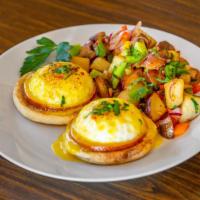 Bistro Benedicts · Two poached eggs on toasted croissant or English muffin topped with hollandaise sauce.